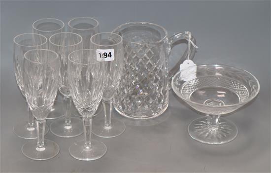 A quantity of Waterford glass including seven champagne glasses, a pedestal bowl and a jug